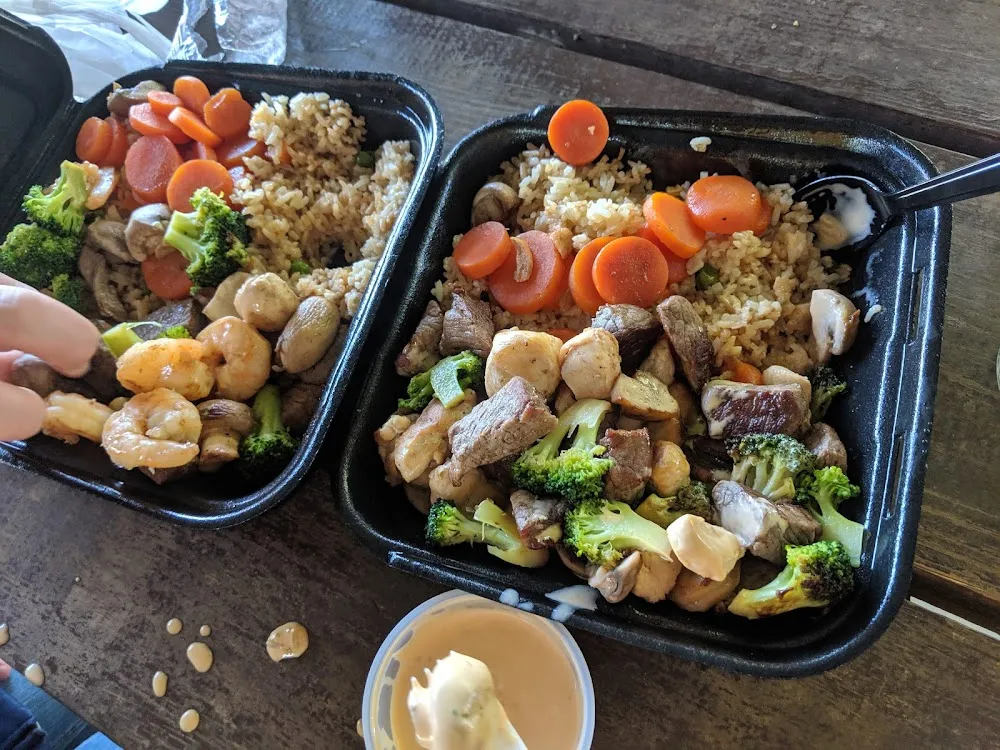 Chicken Shrimp and Steak Combo with Fried Rice Broccoli and Carrots